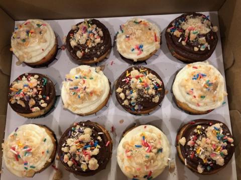 Assorted vanilla and chocolate cupcakes with sprinkles